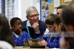 Tim Cook, CEO of Apple Inc with school children 