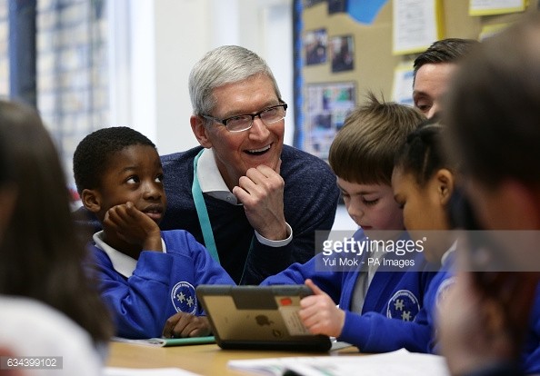 Tim Cook, CEO of Apple Inc with school children 
