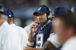  Quarterback Tony Romo #9 of the Dallas Cowboys works with a headset on the sidelines against the Los Angeles Rams at the Los Angeles Coliseum during preseason