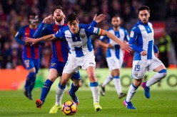 Leganes captain Martin Mantovani (#5) competes for the ball against Barcelona's Lionel Messi.