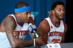 Derrick Rose of the New York Knicks looks on as Carmelo Anthony addresses the media during the New York Knicks Media Day at the Ritz Carlton on September 26, 2016 in White Plains, New York. 
