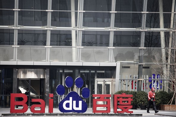 A man walks past a sign for Baidu Inc. at the entrance to the Baidu Technology Park in Beijing, China.