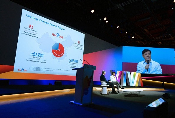 Robin Li (R), founder, chairman and CEO of Baidu talks as Publicis Group Cairman and CEO Maurice Levy listen while attending a session at the Viva technology event in Paris.