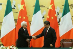 Chinese President Xi Jinping (R) shakes hands with Italian President Sergio Mattarella during a signing ceremony at the Great Hall of the People in Beijing.