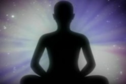 A shadow of man is displayed while he meditates. 