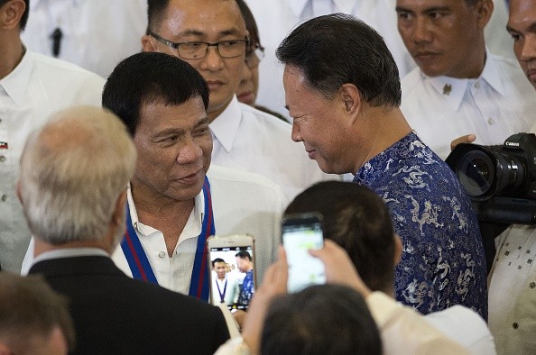Philippine President Rodrigo Duterte (L) talks with Chinese Ambassador to the Philippines Zhao Jianhua.
