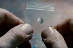 A transparent pill from the movie 'Limitless' is being held by the hand.