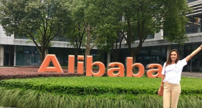 Chloe Goncalves poses in front of a building of Alibaba Group Holding Ltd.