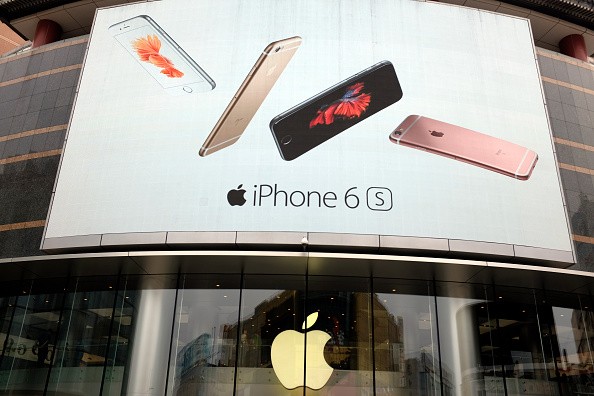A billboard showing Apple phones is seen at an Apple Store in Beijing, China.