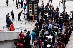 People wait in line for a reading pavilion at Knowledge Square in front of Shanghai Library on March 5, 2017.