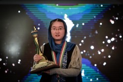 Chinese chess player Tan Zhongyi holds her trophy after she won the Women's World Chess Championship 2017.