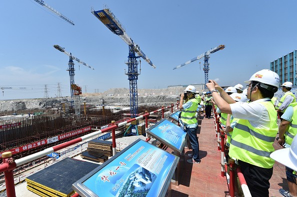 Public representatives and reporters visit a construction site of Hualong One pilot nuclear project in Fuqing, southeast China's Fujian Province.