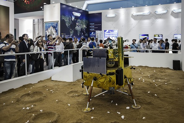 Visitors walk past a model of a Chinese lunar lander at the China International Aviation & Aerospace Exhibition in Zhuhai, China.