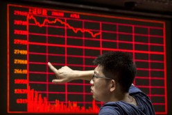 A Chinese day trader reacts as he watches a stock ticker at a local brokerage house on Aug. 27, 2015 in Beijing, China.