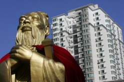 A statue of Confucius is seen with high-rise buildings in the background on Sept. 28, 2006 in Changchun, Jilin Province, China.