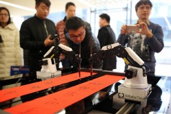 An artificial intelligence robot writes Chinese calligraphy on Jan. 16, 2017 in Hangzhou, Zhejiang Province of China. Hangzhou is one of three recipients of $10 million AI centers from the agreement.