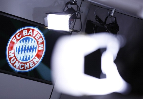 A club logo is seen behind TV lights at the offices of German football club FC Bayern on March 14, 2014 in Munich, Germany.