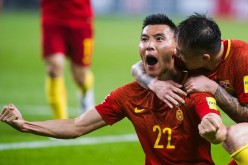 Chinese players celebrate after a major upset against South Korea in the World Cup Qualifiers.