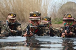 Armed Chinese commandos train in water on March 30, 2016 in Chuzhou, Anhui Province of China.