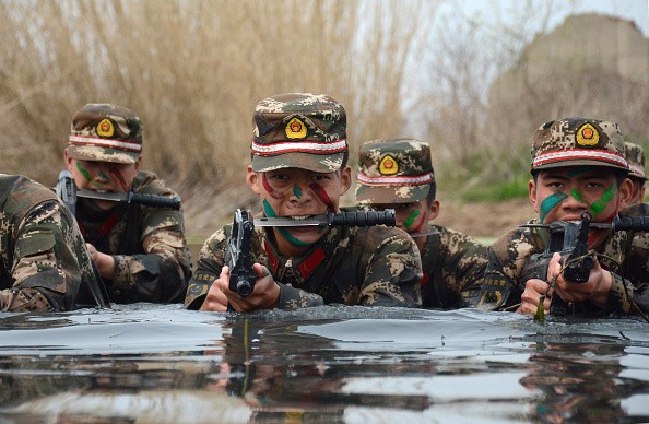 Armed Chinese commandos train in water on March 30, 2016 in Chuzhou, Anhui Province of China.
