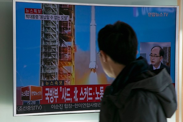 People watch a television screen showing a breaking news on North Korea's long-range rocket launch at Seoul Station on Feb. 7, 2016, in Seoul, South Korea.