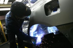 A worker assembles a Hyundai vehicle.