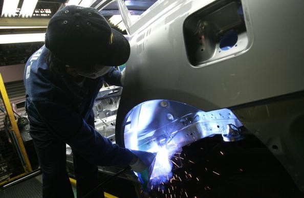 A worker assembles a Hyundai vehicle.