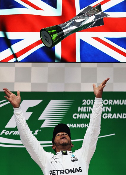 Lewis Hamilton of Mercedes GP celebrates his Grand Prix of China win on the podium.