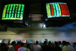 Investors view stock prices displayed on computers at a securities company, June 25, 2007, in Chongqing Municipality, China.