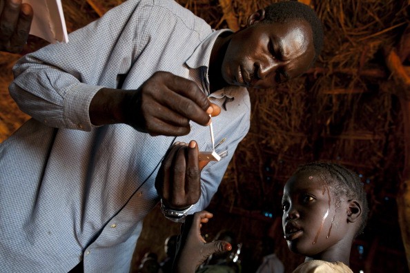 A girl gets tested for malaria at a medical clinic at the Yida refugee camp along the border with North Sudan, July 5, 2012, in Yida, South Sudan.