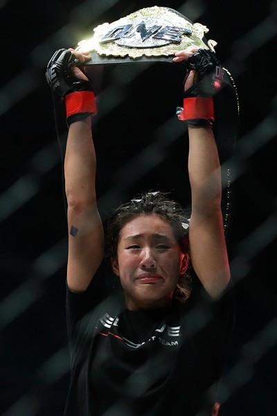 Singapore's Angela Lee celebrates after defeating Japan's Mei Yamaguchi in the women's atomweight world championship bout at 'One Chamionship: Ascent to Power' at Singapore Indoor Stadium in Singapore on May 6, 2016.