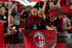 Chinese fans of the AC Milan soccer team sing during a friendly match in Shenzhen, Guangdong province. 