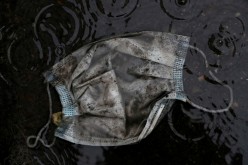  A protective face mask is seen in the rain in Madrid, Spain, 