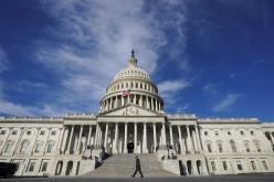 A man makes his way past the U.S. Capitol on the day the House of Representatives is expected to vote on legislation to provide $1.9 trillion in new coronavirus relief in Washington, U.S.,