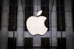An Apple logo hangs above the entrance to the Apple store on 5th Avenue in the Manhattan borough of New York City, 