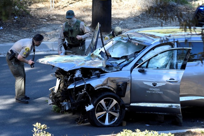 Los Angeles County Sheriff's Deputies inspect the vehicle of golfer Tiger Woods, 