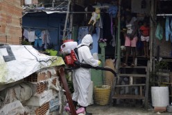 One of the Firmino brothers disinfects the alleys of Santa Marta Slum during the coronavirus disease (COVID-19) outbreak