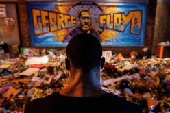  A man recites spoken word poetry at a makeshift memorial honoring George Floyd, at the spot where he was taken into custody, in Minneapolis, Minnesota, U.S.