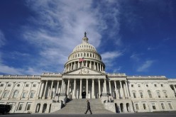 A man makes his way past the U.S. Capitol on the day the House of Representatives is expected to vote on legislation 