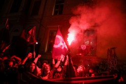 Demonstrators light flares during a rally to mark the International Women's Day in Istanbul, Turkey 