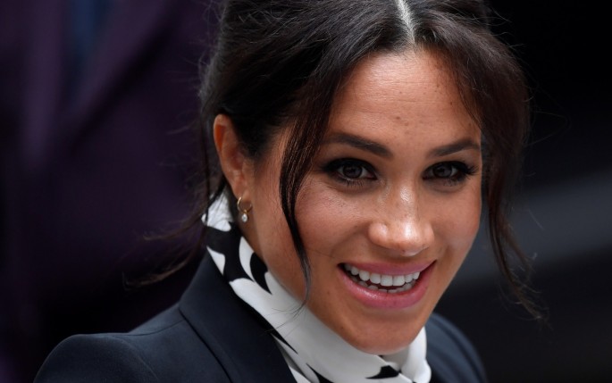 Britain's Meghan, Duchess of Sussex, reacts as she leaves after an International Women's Day panel discussion at King's College London,