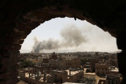 Smoke and dust rise near buildings from air strikes launched by Saudi-led coalition on Sanaa,