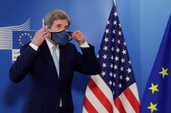 US Special Presidential Envoy for Climate John Kerry holds his mask after a meeting in Brussels, Belgium, 