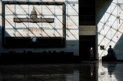 A member of the National Guard walks through the Capitol Visitor Center as the House of Representatives