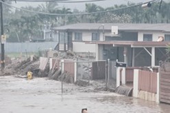 Floodwaters stream down a street in Hauula, Hawaii, U.S. March 9, 2021, in this still image obtained from a social media video.