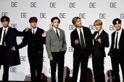Members of K-pop boy band BTS pose for photographs during a news conference promoting their new album 