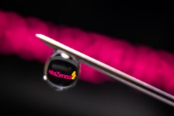 AstraZeneca logo is reflected in a drop on a syringe needle in this illustration photo taken 