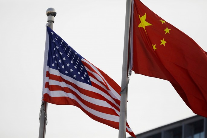 Chinese and U.S. flags flutter outside the building of an American company in Beijing, China 
