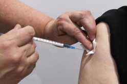 A person receives a dose of Oxford/AstraZeneca's COVID-19 vaccine at a vaccination centre in Antwerp, Belgium 