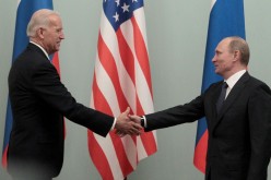 Russian Prime Minister Vladimir Putin (R) shakes hands with U.S. Vice President Joe Biden during their meeting